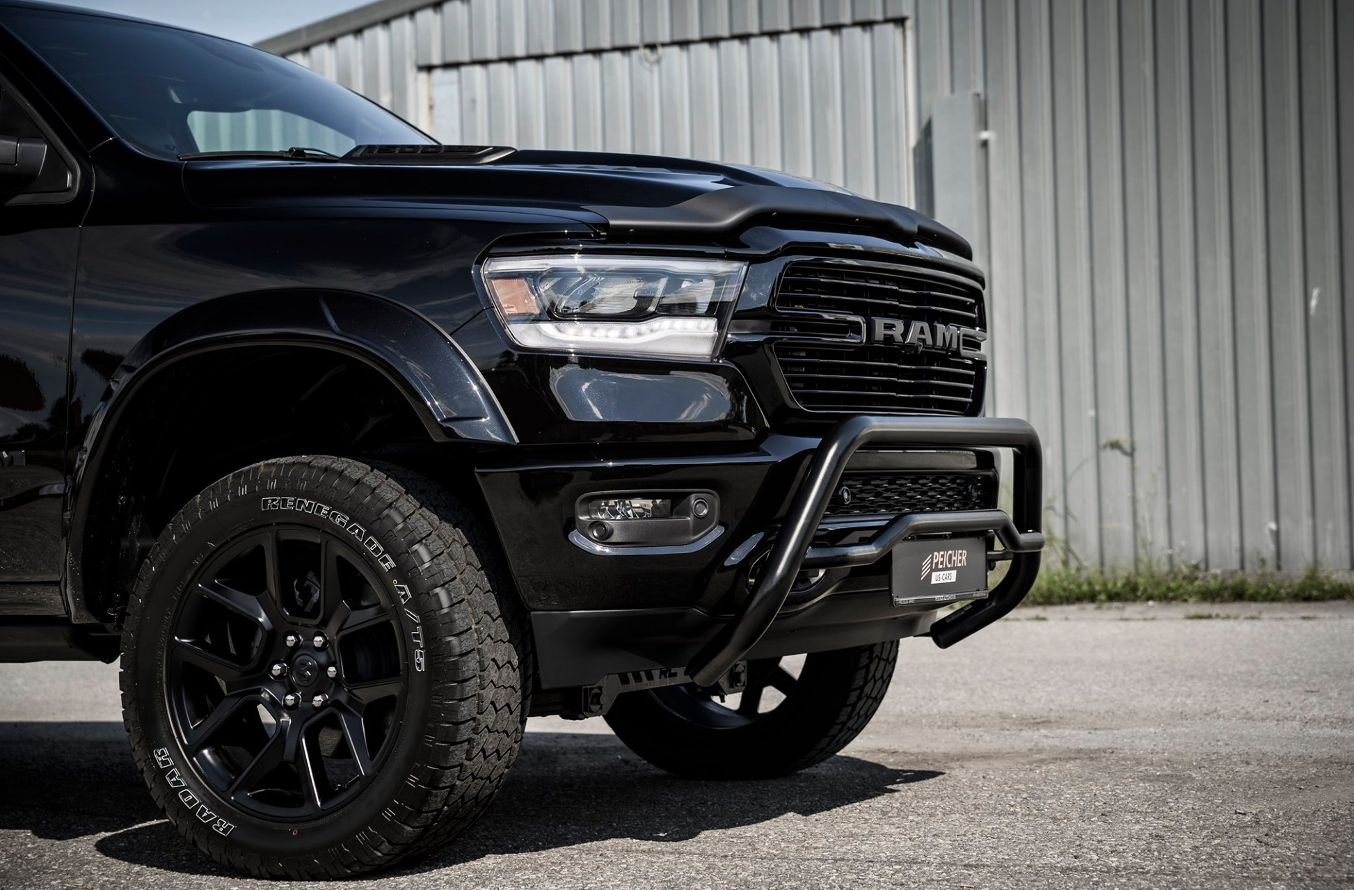Front quarter view of a black bullbar installed on a black dodge ram