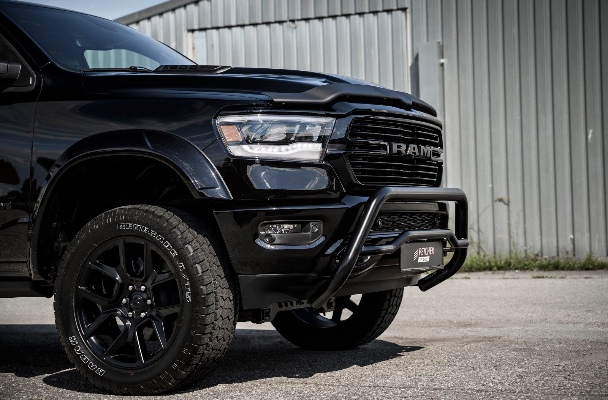 Front quarter view of a black bullbar installed on a black dodge ram