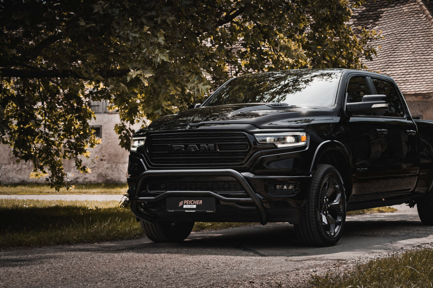 Black Dodge Ram with a black bullbar in rural village