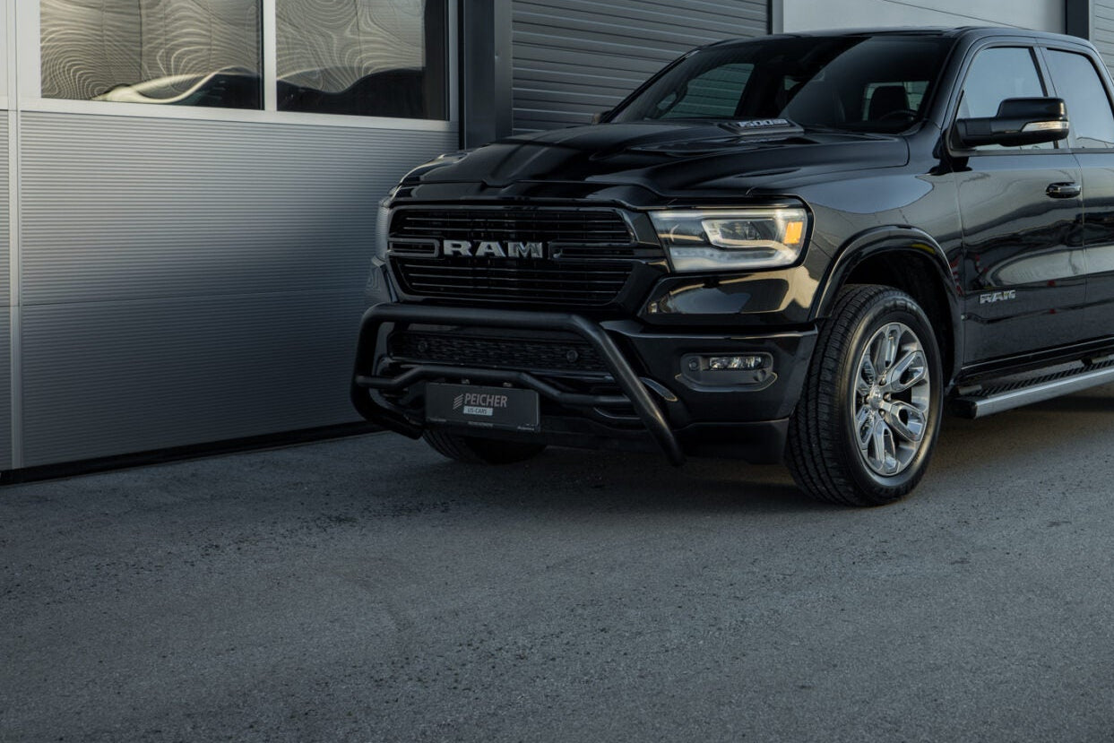 Side quarter view of a black bullbar on a black Dodge Ram gen 5